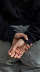 A woman's hands behind her back