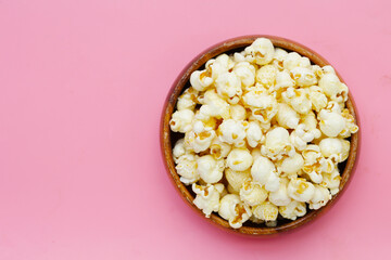 Sweet popcorn on pink background.