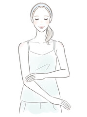 肌を触って微笑む女性