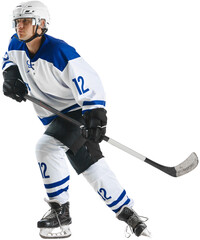 Young man, athlete, hockey player in uniform and helmet, standing on rink with stick against transparent background. Concept of professional sport, competition, game, tournament, match, action