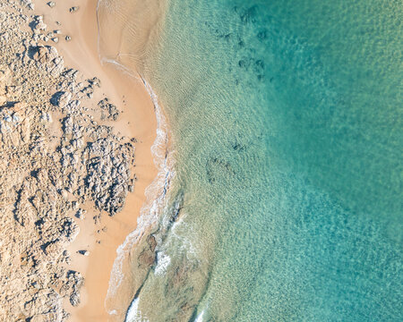 Nice holiday destination with beach and gentle waves view from above