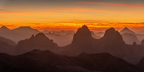 Hoggar landscape in the Sahara desert, Algeria. A view from Assekrem of the sunrise over the Atakor mountains - 739879647