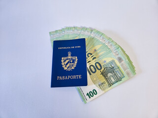 An ordinary Cuban passport with several euro bills, on a white background.