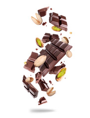Levitation of crushed dark chocolate bar with pistachios in the air isolated on a white background