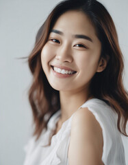 Fototapeta premium Portrait of an Asian young woman with a happy and sincere smile, isolated white background. copy space for text 