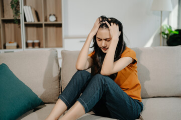 Obraz premium woman sit Depression Dark haired pensive glance Standing on sofa by window