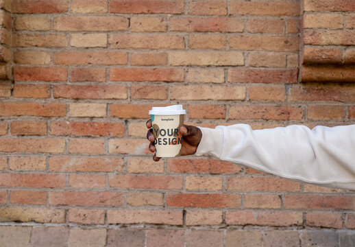 Mockup of man holding customizable disposable cup