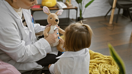 A woman in a lab coat uses a stethoscope on a toy kangaroo, watched by a child dressed as a doctor...