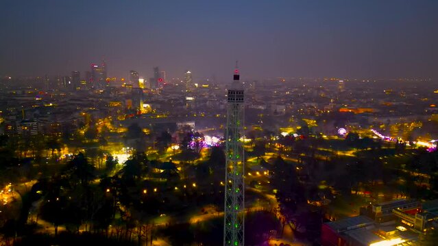 Sunset Spectacle Aerial Views of Milan Cityscape with Branca Tower. Drone flying at night