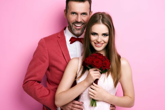 Portrait Man Embracing Woman With Bunch Roses