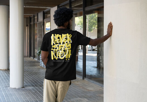 Mockup of man leaning on wall, customizable t-shirt