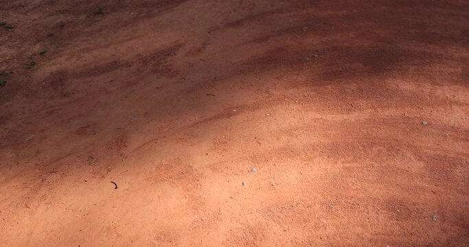 a red sand walking path in the park, a walking red path made of rammed sand after sweeping