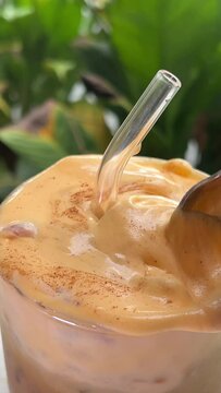 Vietnamese Egg Coffee. Paleo, Dairy-free keto coffee latte drink with sweet sugared Whipped yolks Top view a cup of Giang egg coffee on wood background. Vietnamese coffee. Eggs are beaten with coffee