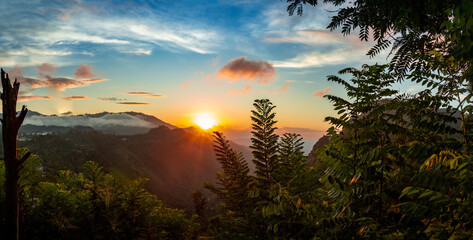 Golden Glow: Majestic Sunrise Over Mountainous Horizon, Radiant Blue and Orange Sky, Nature's...