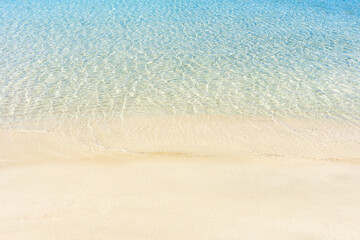 Fototapeta na wymiar Soft blue sea wave on clean sandy beach. Elafonisi Greece.