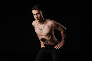 Fototapeta premium Yogic man practices abdominal vacuum technique for core strength.