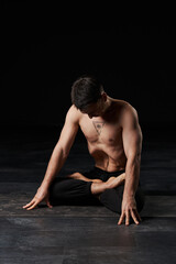 Sitting in lotus, perfecting stomach vacuum, the man's chest tattoo of an all-seeing eye exudes...