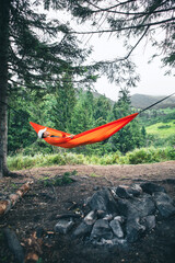 happy woman on hammock mountains on background