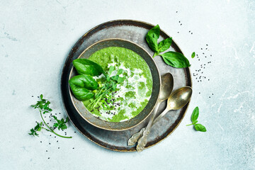 Vegan Spinach cream soup with cream. In a bowl. The concept of vegetarian food.