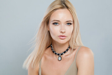 Stylish fashion jewelry model woman. Lady with fresh clean skin, blonde hair and necklace on her...