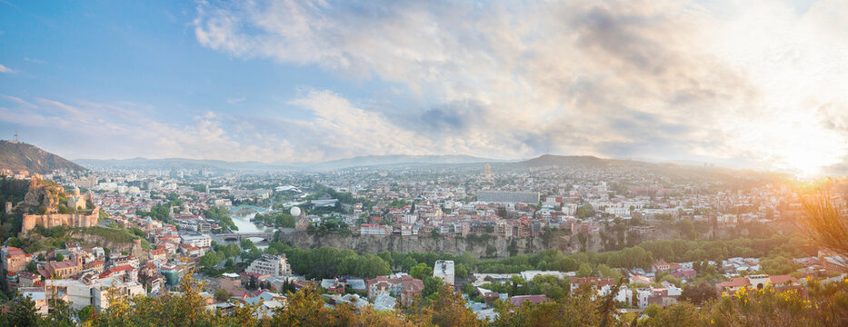 Panoramic landscape of old Tbilisi on the background of spectacular blue sky with clouds