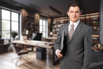 Happy professional business man employee standing in office