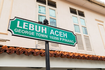 Lebuh Aceh (Aceh Street) Street Sign in George Town UNESCO World Heritage Site with surrounding buildings as background