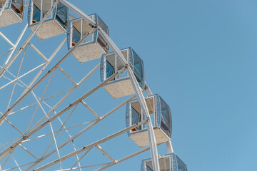 View of modern ferris wheel on background of blue sky in Kyiv city.