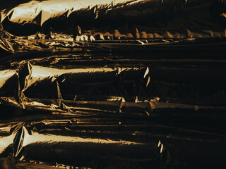 Golden light reflected on foil at night for an abstract luxury background. 