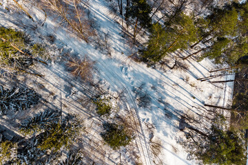 View from above of a country road in a winter forest