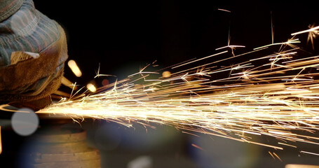 Welding of metal structures with sparks, close-up.