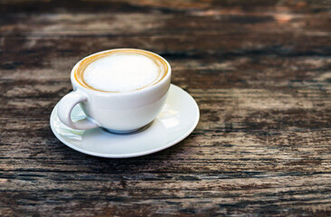 Hot cappuccino cup on wooden table