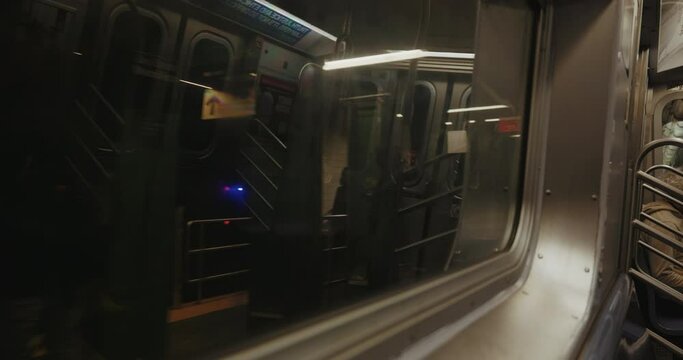 View from the window of a moving train of the New York underground going through a tunnel.