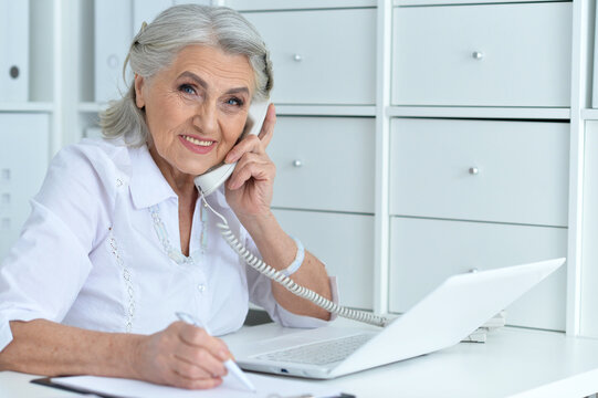 Portrait of senior business woman talking with phone