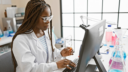 African american woman in lab analyzing sample computer research scientist glasses