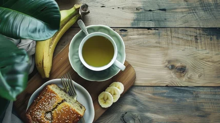 Foto auf Acrylglas hot green tea and banana cake on wooden floor © buraratn