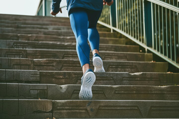 casual jogger taking evenly paced steps on riverside stairs