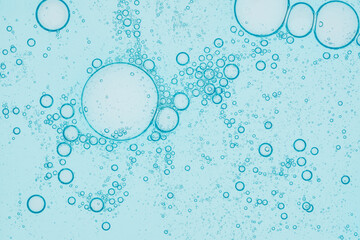Close-up of serum or cosmetic gel in trendy blue color. . Collagen, hyaluronic acid for skin care. Macro bubbles background