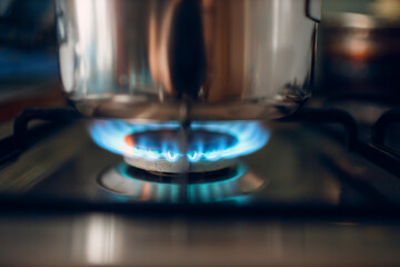 Burning gas flame on a kitchen gas stove saucepan