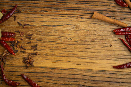 Dried red chili peppers on wooden background. Top view, copy space