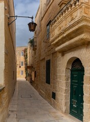 typical yellow-ochre limestone buildings in the old town of Mdina in Malta