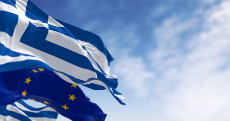 National flags of Greece waving in the wind with flag of the European Union