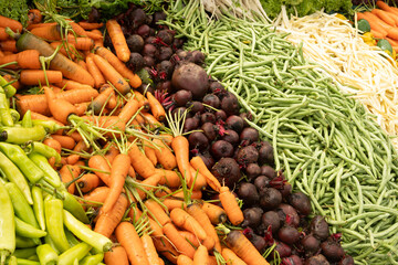 Fresh different vegetables, green bean, beetroot, pepper, carrot on Asian market as background. Organic texture. Local food and vegetables. Agriculture. Close up.