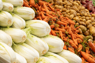 Fresh different vegetables, chinese cabbage, carrot, potato on Asian market as background. Local food and organic vegetables. Agriculture. Close up.