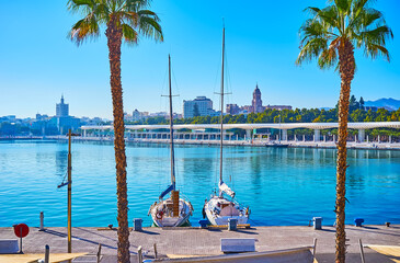 Two sail yachts against the city skyline, Malaga Port, Spain