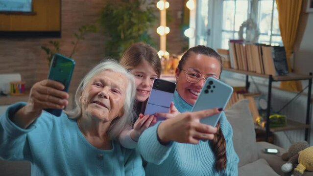 Happy child, mother and grandmother take selfie photos for social media with their phones at home