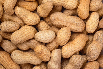 Pile of organic peanuts close-up. Peanut food background.