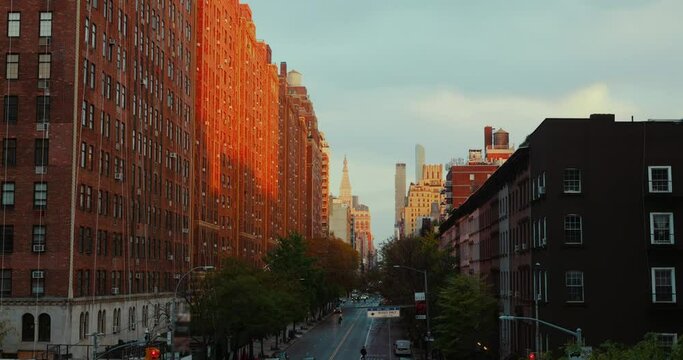 Beautiful panoramic shot of Manhattan during sunset. The setting sun reflects on the facades of typical brick houses.