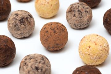 Chocolate truffle candies on a white background, close-up