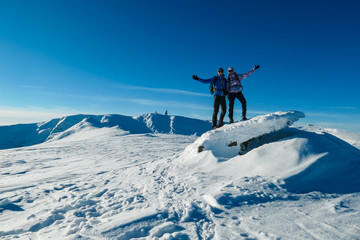 Couple in snowshoes on snow covered mountains of Kor Alps, Lavanttal Alps, Carinthia Styria,...